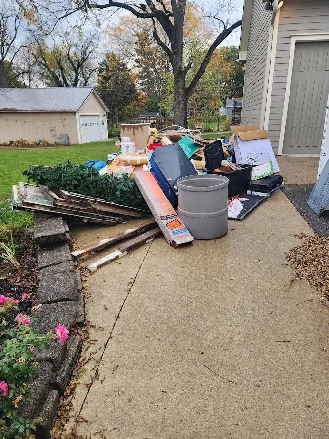 Dumpster being loaded with debris for 10 Yard Dumpster Rental in Monson